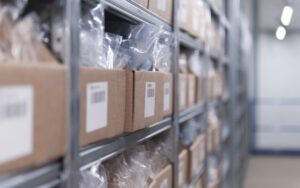 managing customer expectations and carrier options- cardboard boxes filled with plastic bags on a shelf