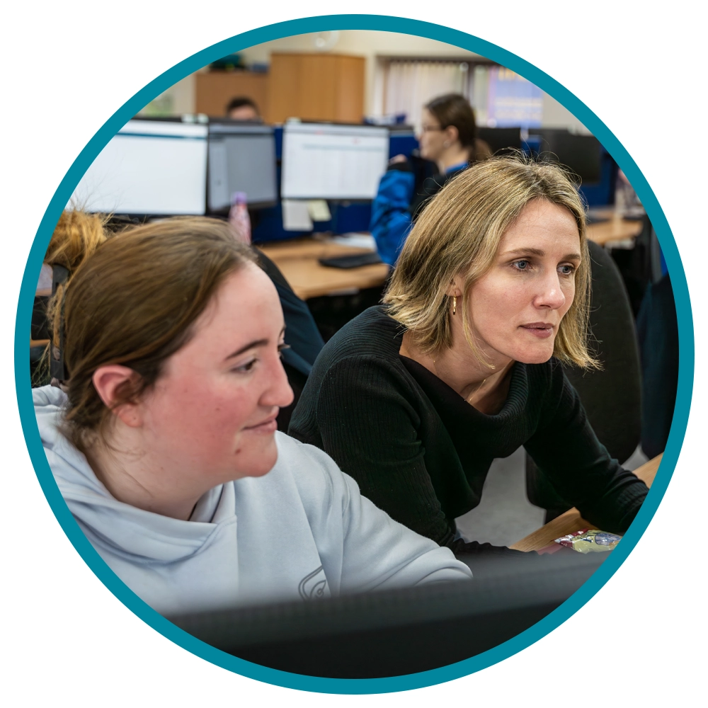 business insights- two people looking at a computer screen