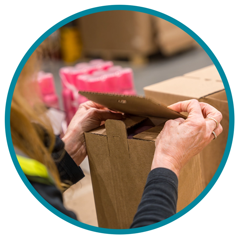 contract packing- cardboard box being closed by hand