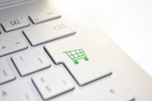 top tips for retailers- a white keyboard with a green shopping cart symbol on the enter key
